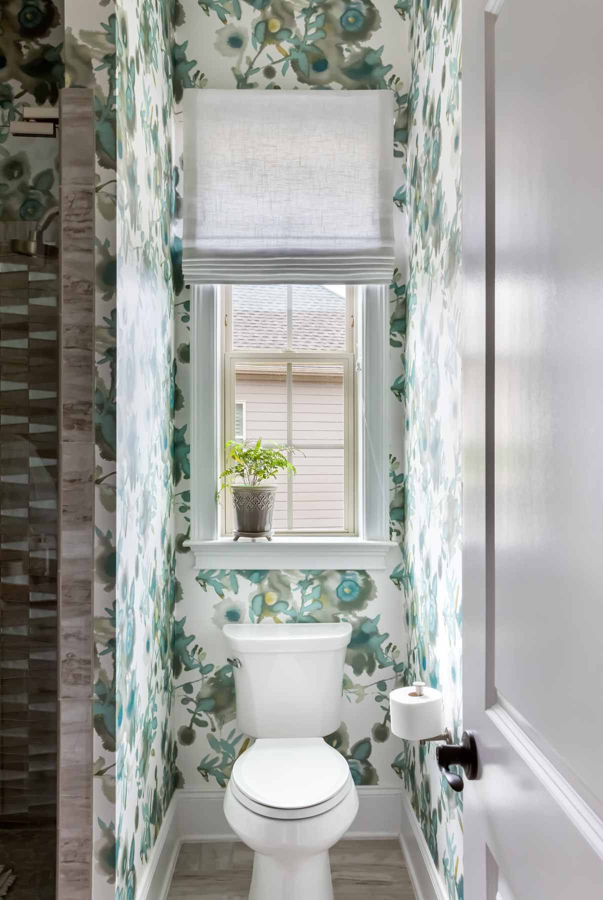 bathroom with floral green and blue wallpaper